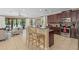 Open kitchen with a large island with bar seating, stainless steel appliances and backyard view at 852 Desert Mountain Ct, Reunion, FL 34747