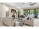 Cozy living room with tile floors, two sofas, and a sliding glass door leading to the outdoor pool area at 852 Desert Mountain Ct, Reunion, FL 34747
