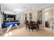 The expansive living room with a foosball table, games, and comfortable seating for entertainment at 852 Desert Mountain Ct, Reunion, FL 34747