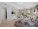 Serene main bedroom featuring double doors, an entertainment center, and leafy decor at 852 Desert Mountain Ct, Reunion, FL 34747