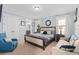 Relaxing main bedroom with a large bed, neutral tones, plenty of natural light and an ensuite bathroom at 852 Desert Mountain Ct, Reunion, FL 34747