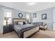 Comfortable main bedroom with a cozy sitting area, large bed, stylish decor, and ample natural light at 852 Desert Mountain Ct, Reunion, FL 34747