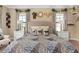 Comfortable main bedroom with natural light, decorative mirrors, and exotic animal print comforter at 852 Desert Mountain Ct, Reunion, FL 34747