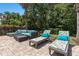 Pool area with lounge chairs and a seating area surrounded by lush landscaping at 852 Desert Mountain Ct, Reunion, FL 34747