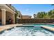 Hot tub spilling into pool, overlooking patio with barbeque at 852 Desert Mountain Ct, Reunion, FL 34747