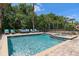 Pool with jacuzzi and patio furniture on a sunny day at 852 Desert Mountain Ct, Reunion, FL 34747