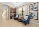 Charming sitting room with blue chairs, custom built-ins, and decorative artwork, creating a cozy and inviting space at 852 Desert Mountain Ct, Reunion, FL 34747
