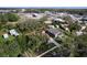A charming blue home with a red roof sits on a well-maintained lot with mature trees at 1938 E Fern Rd, Lakeland, FL 33801