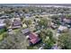 Aerial view of a residential area with cozy homes surrounded by lush trees and greenery at 1938 E Fern Rd, Lakeland, FL 33801