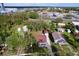 Aerial view of a single-Gathering home, detached garage and wooded lot in a residential neighborhood at 1938 E Fern Rd, Lakeland, FL 33801