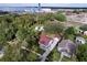 Birds eye view of single-Gathering home, detached garage and wooded lot in residential neighborhood at 1938 E Fern Rd, Lakeland, FL 33801
