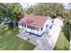 Aerial view of a cozy home with a detached garage, nice yard, and inviting curb appeal at 1938 E Fern Rd, Lakeland, FL 33801