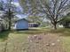 Expansive backyard with mature trees, offering plenty of space for outdoor activities at 1938 E Fern Rd, Lakeland, FL 33801