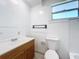 Cozy bathroom featuring a wooden vanity, white countertop, and new flooring at 1938 E Fern Rd, Lakeland, FL 33801