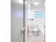 Clean white bathroom with updated fixtures and a bright window for natural light at 1938 E Fern Rd, Lakeland, FL 33801