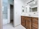 Bathroom with wood vanity, granite countertops, and a shower/tub combo at 1938 E Fern Rd, Lakeland, FL 33801