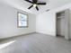 Bedroom featuring bright window, ceiling fan, and closet access for streamlined living at 1938 E Fern Rd, Lakeland, FL 33801