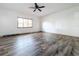 A bright, spacious bedroom with hardwood floors and a modern ceiling fan at 1938 E Fern Rd, Lakeland, FL 33801