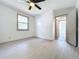 Bedroom features light gray floors, ceiling fan, and a doorway that leads to other rooms at 1938 E Fern Rd, Lakeland, FL 33801