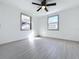 Well-lit bedroom with two windows providing natural light, complemented by sleek flooring at 1938 E Fern Rd, Lakeland, FL 33801