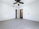 Spacious bedroom features clean design, ceiling fan, and sleek, modern flooring at 1938 E Fern Rd, Lakeland, FL 33801
