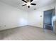 Bright bedroom features light gray floors, ceiling fan, and a doorway that leads to other rooms at 1938 E Fern Rd, Lakeland, FL 33801
