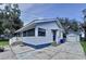 View of the home showcasing the porch, garage and the surrounding driveway at 1938 E Fern Rd, Lakeland, FL 33801