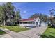 Charming single-story home featuring a cozy front porch, detached garage and well-maintained lawn at 1938 E Fern Rd, Lakeland, FL 33801