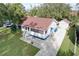 Aerial view of a charming single-story home with a well-maintained yard and detached garage at 1938 E Fern Rd, Lakeland, FL 33801