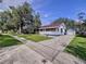 Charming single-story home featuring a well-maintained lawn, driveway, and detached garage at 1938 E Fern Rd, Lakeland, FL 33801