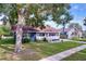 Charming single-story home featuring a cozy front porch and well-maintained lawn at 1938 E Fern Rd, Lakeland, FL 33801