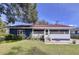 Charming single-story home featuring a well-maintained lawn and screened-in porch at 1938 E Fern Rd, Lakeland, FL 33801