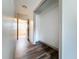 Hallway with hardwood floors and access to other rooms including a closet at 1938 E Fern Rd, Lakeland, FL 33801