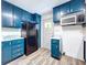 A well-lit kitchen with updated blue cabinetry, marble countertops, and appliances for a fresh look at 1938 E Fern Rd, Lakeland, FL 33801