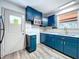 Modern kitchen with blue cabinets, marble countertops, updated appliances, and new faucet at 1938 E Fern Rd, Lakeland, FL 33801