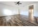 Spacious living room with neutral walls, updated flooring, and a ceiling fan providing comfort at 1938 E Fern Rd, Lakeland, FL 33801