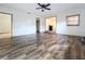 Bright living room features modern vinyl flooring, ceiling fan, and natural light from a window at 1938 E Fern Rd, Lakeland, FL 33801