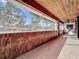 Inviting covered porch with wood paneling and tile flooring, perfect for relaxation at 1938 E Fern Rd, Lakeland, FL 33801