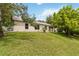 Backyard features lush green grass, healthy trees and a white fence at 818 Cherry Laurel St, Minneola, FL 34715