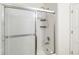 Bathroom with glass shower door, shower head, shower caddy and tub at 818 Cherry Laurel St, Minneola, FL 34715