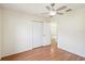 This bedroom features wood floors, a ceiling fan, and double closets for ample storage at 818 Cherry Laurel St, Minneola, FL 34715