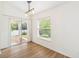 Bright dining room with sliding glass doors to backyard, wood flooring, and lots of natural light at 818 Cherry Laurel St, Minneola, FL 34715