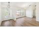 Bright entryway features hardwood floors, decorative glass front door, modern lighting, and a sidelight window at 818 Cherry Laurel St, Minneola, FL 34715
