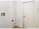 Laundry room with connections for a washing machine and dryer and a white door at 818 Cherry Laurel St, Minneola, FL 34715