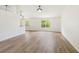 Spacious open living area featuring hardwood floors and large windows offering plenty of natural light at 818 Cherry Laurel St, Minneola, FL 34715
