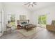 Bright bedroom features a ceiling fan, a walk-out to the patio, and neutral decor at 818 Cherry Laurel St, Minneola, FL 34715