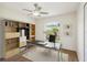 Bright home office with built-in shelving, a large window, and wood laminate flooring at 818 Cherry Laurel St, Minneola, FL 34715