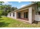 Covered back patio featuring access via sliding doors and a view of the backyard at 818 Cherry Laurel St, Minneola, FL 34715