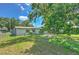 Spacious backyard featuring lush greenery, a chain-link fence, and mature trees providing ample shade at 475 W Ethelene St, Bartow, FL 33830