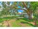 A lovely backyard, showcasing a spacious lawn, large tree, and serene outdoor space at 475 W Ethelene St, Bartow, FL 33830
